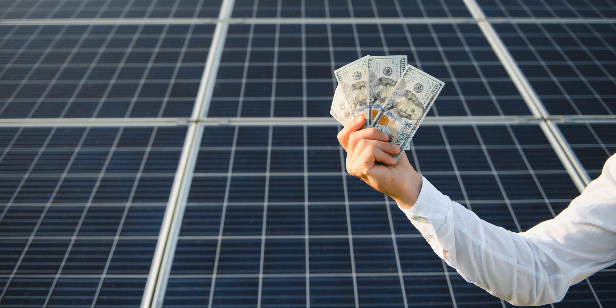 A sales persona showing dolars with a background of solar paneles 